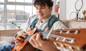 Young person playing guitar