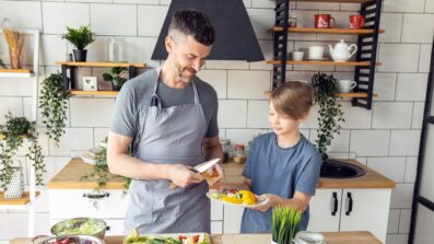 Young person and support worker in kitchen